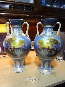 FINE NORITAKE PORCELAIN HAND PAINTED TWO HANDLED VASE. Matching pair. 11inch high